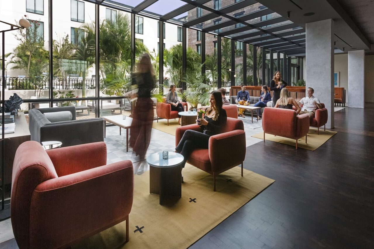 People chatting in plush chairs at Flor Fina restaurant in Ybor City, FL