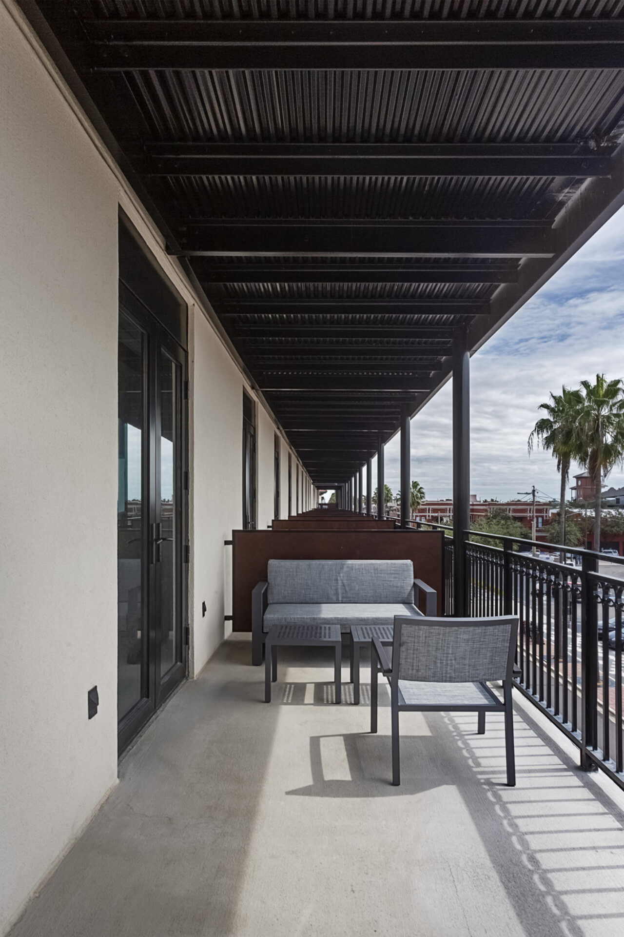 Gray chairs on a balcony at our boutique hotel near Tampa airport