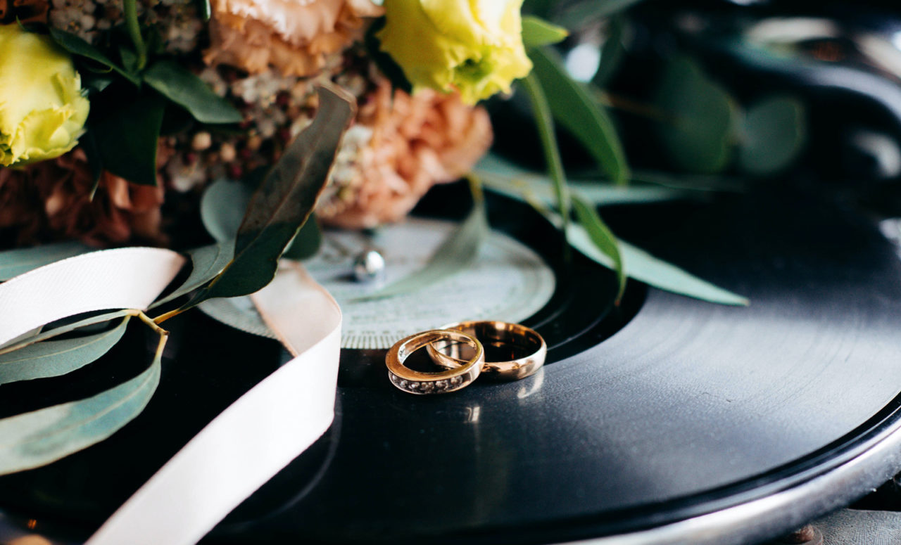 Wedding rings on a table surrounded by flowers at our Ybor City hotel