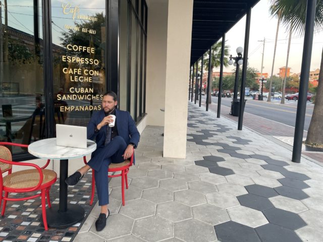 Man sitting outside the cafe at our hotel in Ybor City, Florida