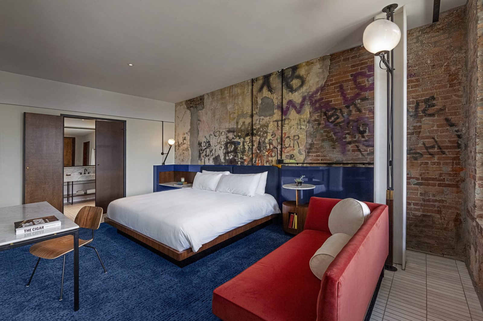 Red sofa and blue carpeting at our boutique hotel in Tampa, FL