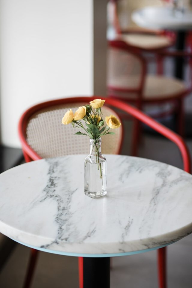 Yellow flowers in a bottle at our Tampa hotel with a pool bar