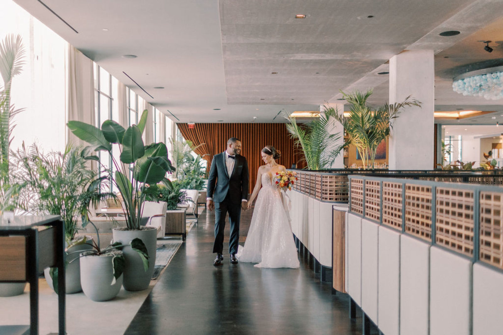 Bride and groom surrounded by tropical plants at our Ybor City hotel