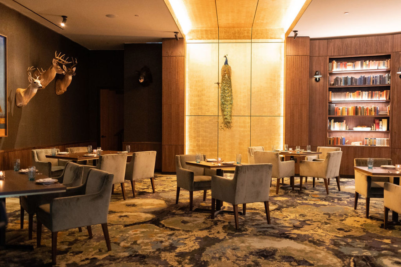 Restaurant at our Ybor City, Tampa hotel with plush chairs and animal decorations