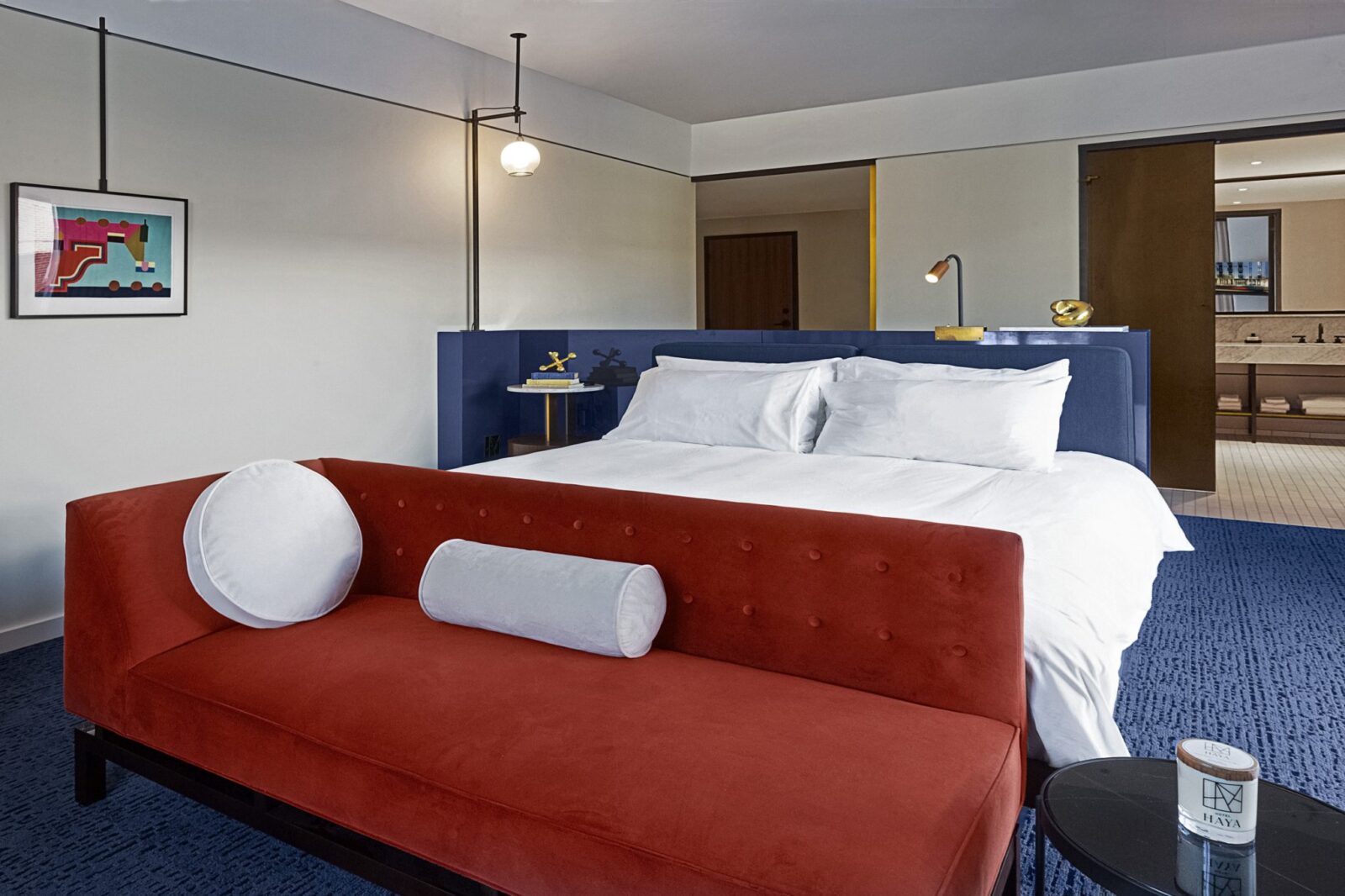 Red sofa at the foot of a bed at our Ybor City Tampa hotel