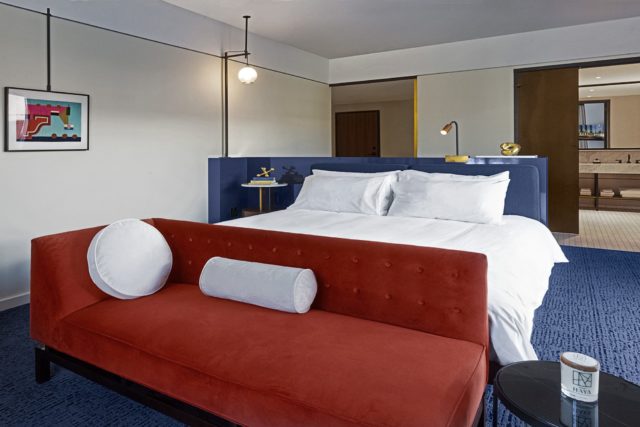 Red sofa at the foot of a bed at our Ybor City Tampa hotel