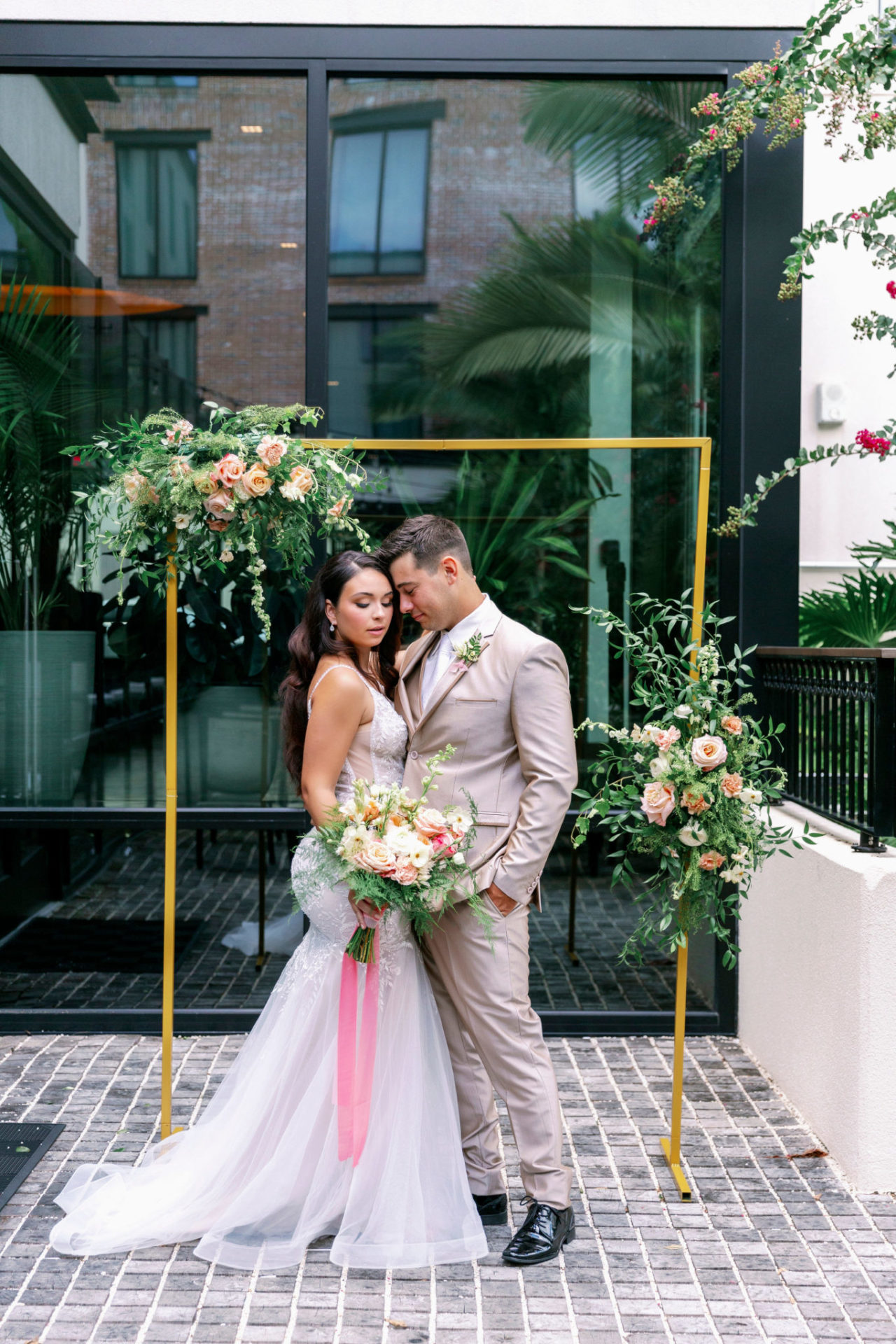 Bride and groom posing with flowers at our hotel in Ybor City, Tampa