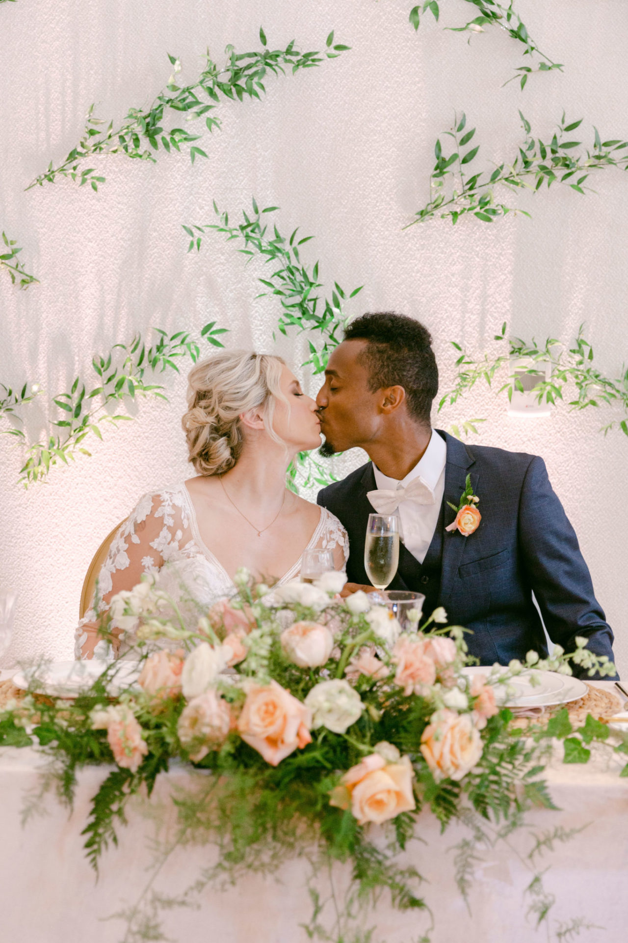 Bride and groom kissing behind a large bouquet at our Ybor City hotel